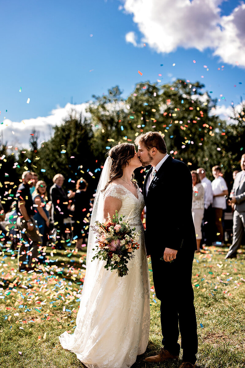 bride and groom with confettie