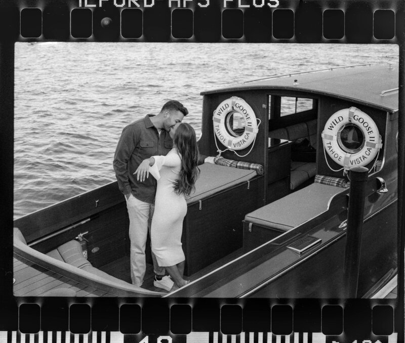 black and white photo of man and woman getting married on a boat on lake tahoe