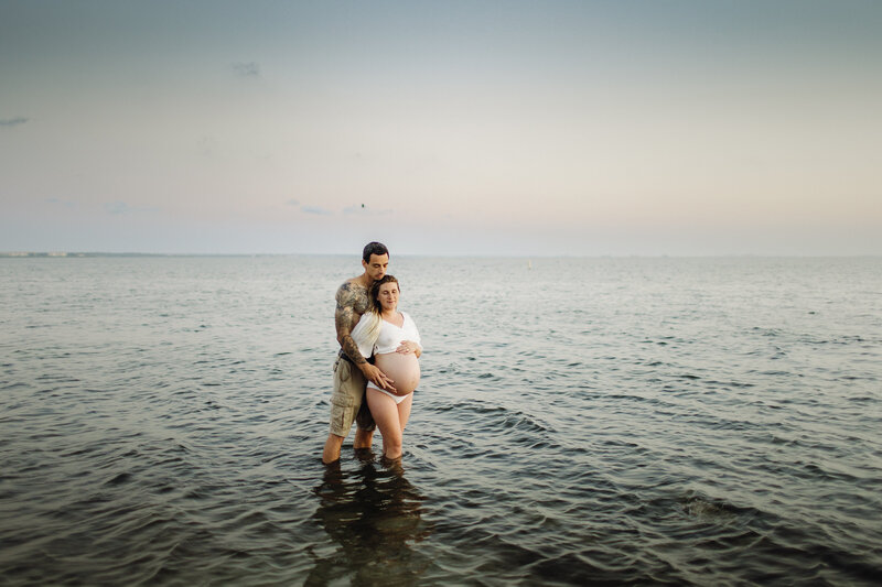 maternity photography couples photo pregnant woman with husband in ocean tampa bay, florida nadine b photography
