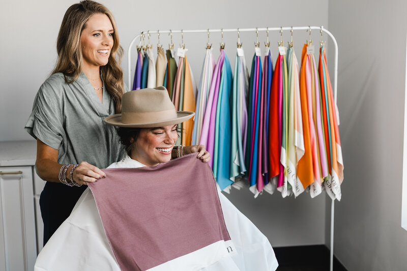 Elizabeth assessing a woman's hair tones