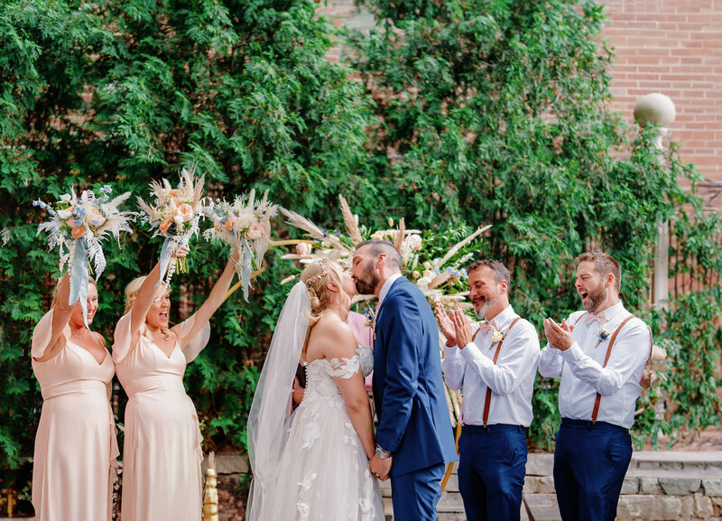 bride and groom first kiss at ceremony