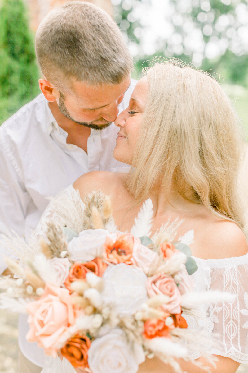 engagement photo of couple with bouquet