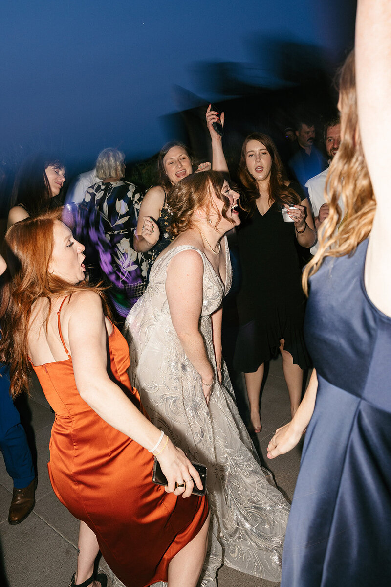 Flash photo of bride dancing with guests at Nashville wedding reception