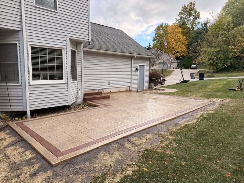 Stamped concrete patio with a contrasting border in fall in Middlebury, IN