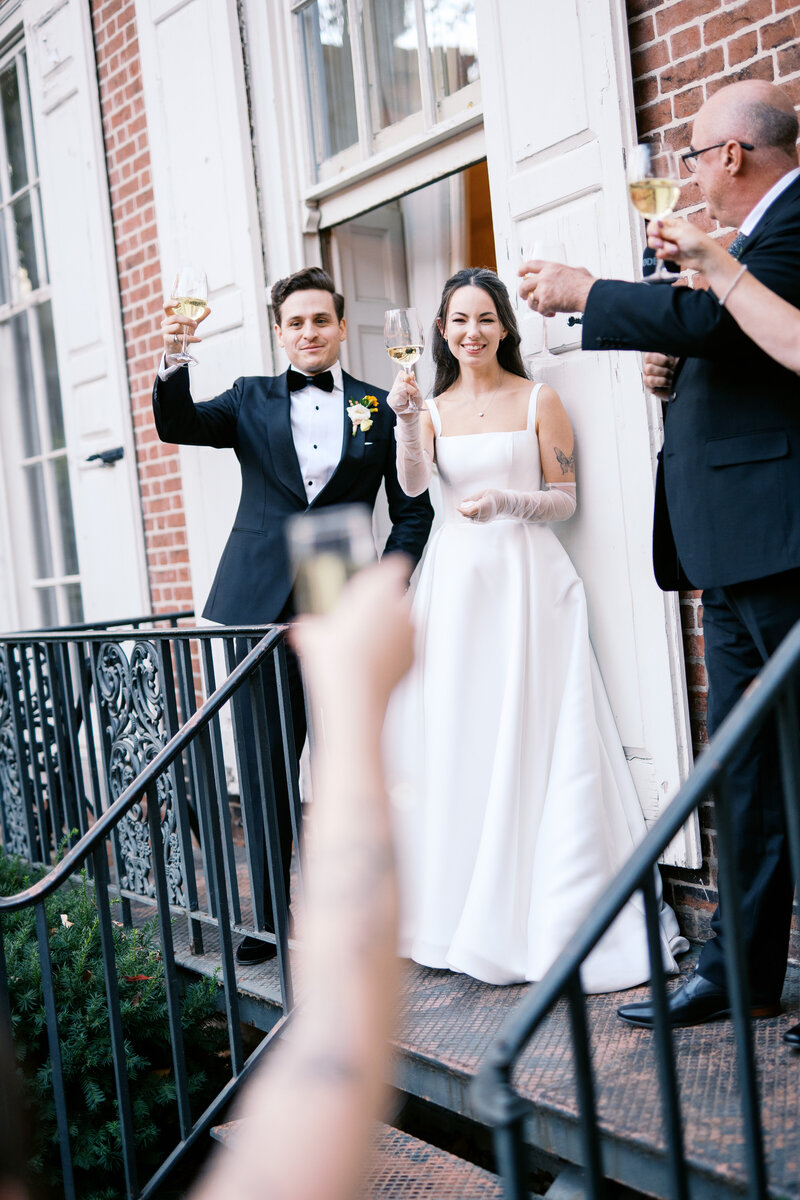 Groom holding a drink at cocktail hour at Glen Foerd Estate in Philadelphia, PA