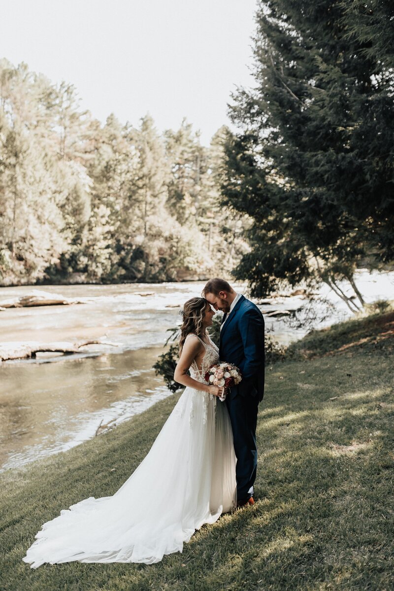 Couple embracing during first look near North Georgia RIver Photo Logan Simmons