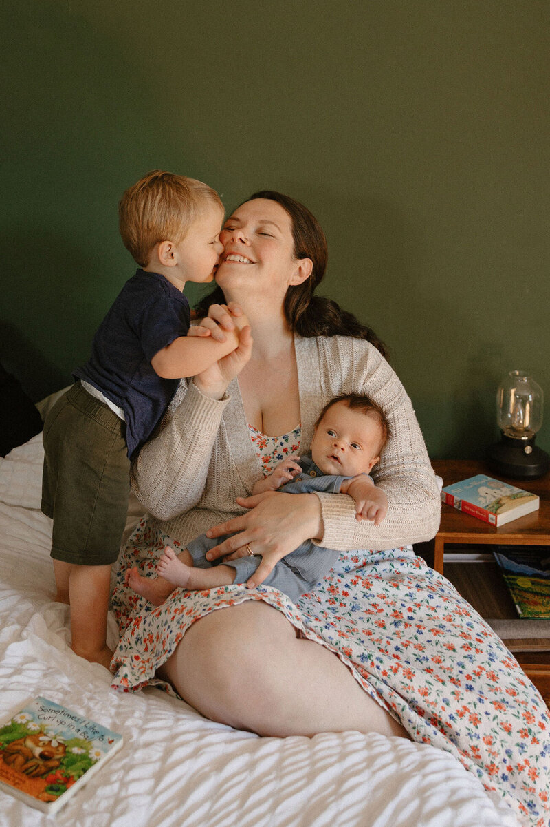 Maternity Photographer holding a toddler and smiling at a park in Oregon