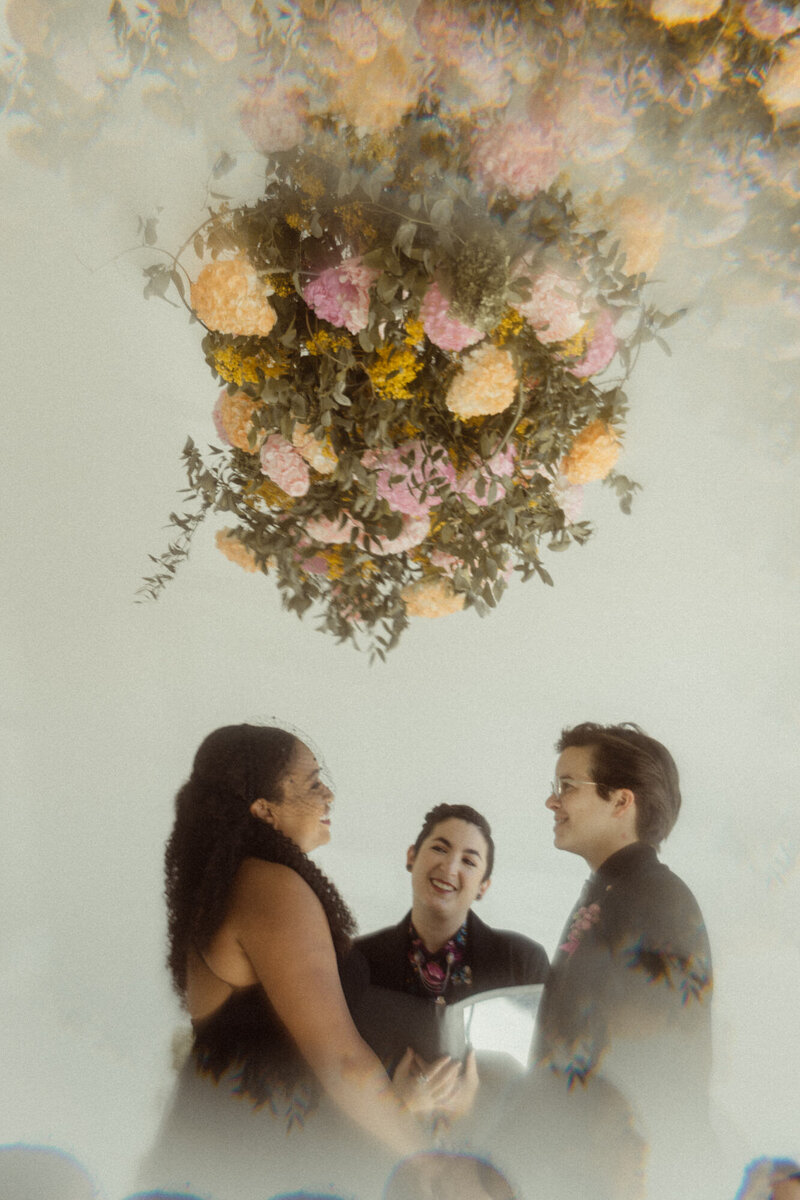 A couple standing up saying their vows.