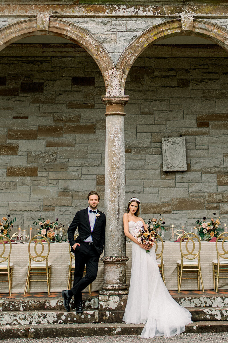 Tiffany Longeway Photography captures the sophisticated and timeless elegance of a wedding at Château St. Jean in Sonoma Valley, California. The grand stone arches and beautifully arranged reception table create a stunning backdrop, perfect for couples seeking a historic and luxurious venue for their wedding celebration.