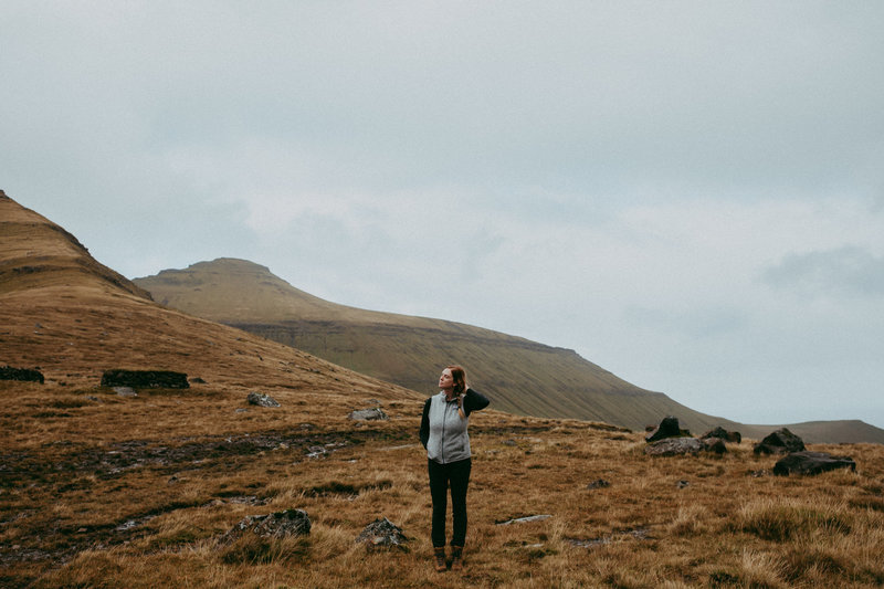 woman  standing near mountains in field