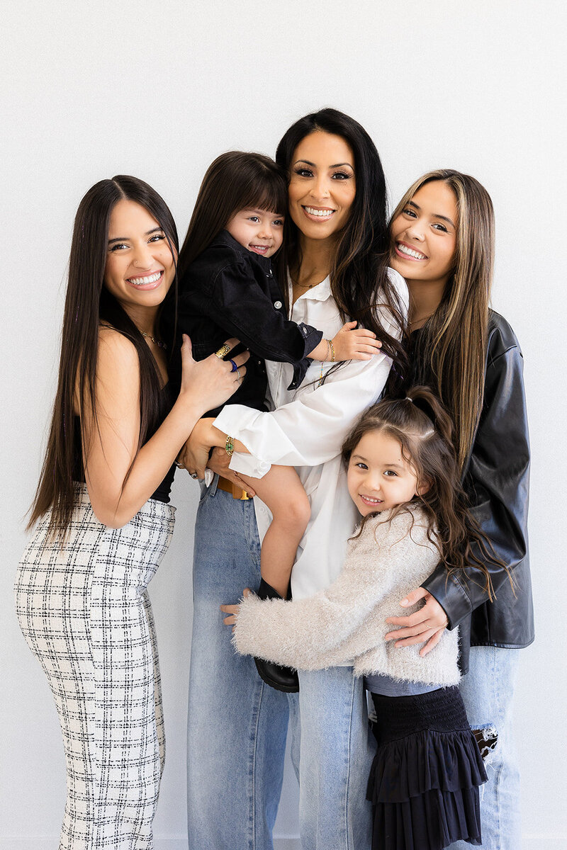 mom poses with four children during family photos in las vegas