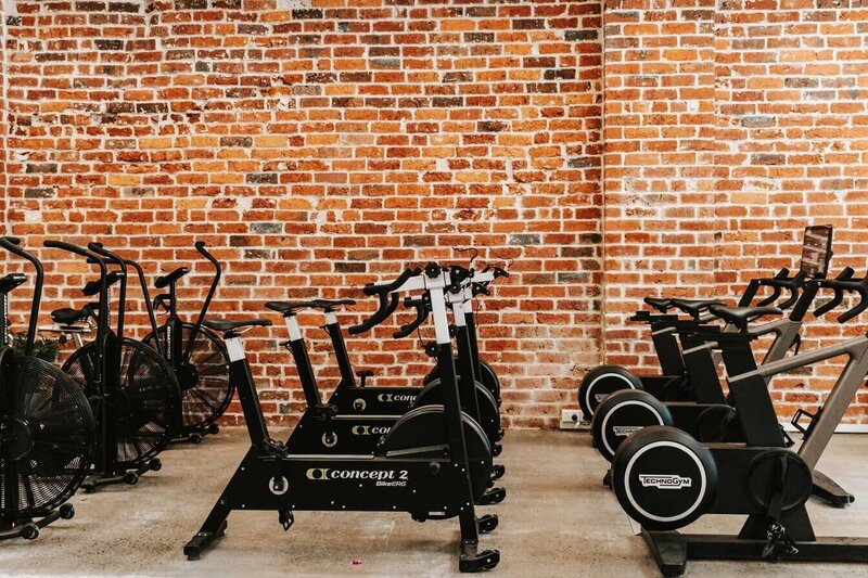 women strength training on rings in  a gym with fitness passport in melbourne