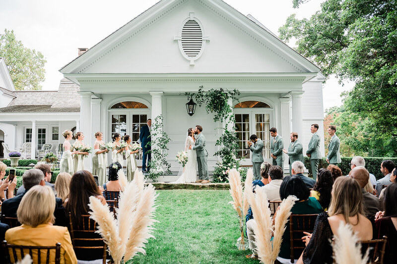 A bride and groom sharing their first kiss during their wedding ceremony 