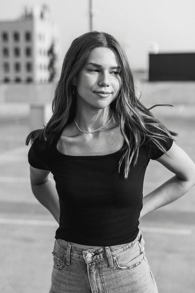 A black and white photo of a graduating senior wearing a black tshirt
