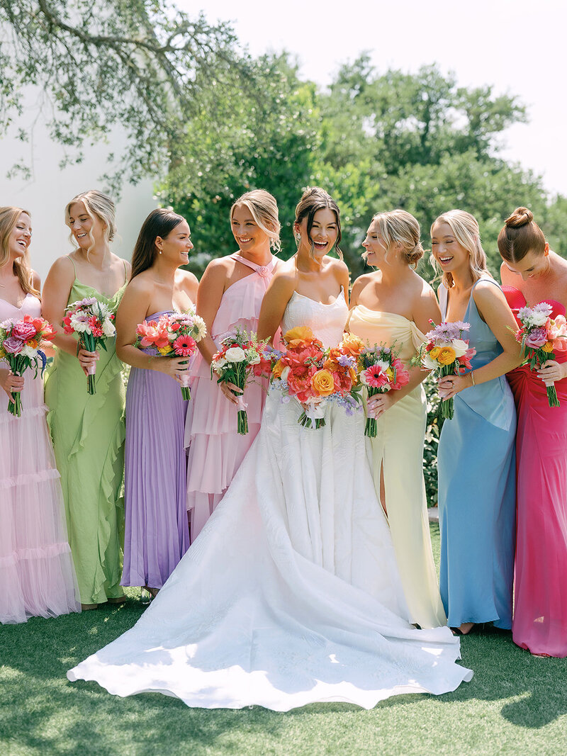 Bride and bridesmaids in colorful dresses at wedding planned by Bianca Nichole and Co