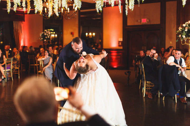 Bride dipped back during romantic first dance at the rusty pelican venue.