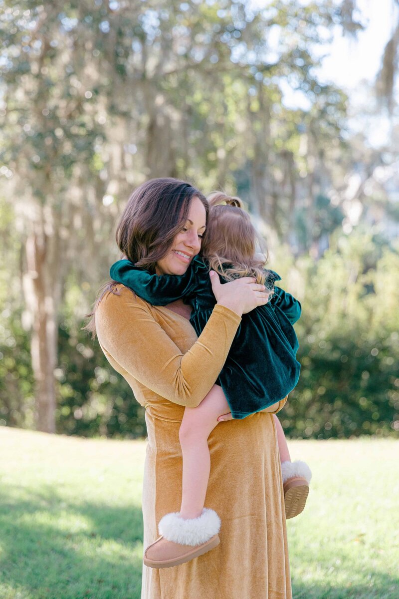 Mom cuddling toddler girl for Palmetto Bluff Photographer Lamp and Light Photography