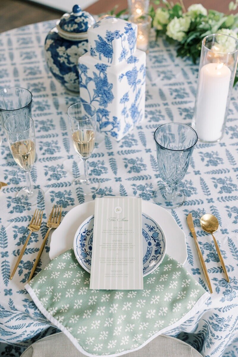 Close-up of an elegant wedding place setting with fine china and floral details, photographed at a Milwaukee wedding reception