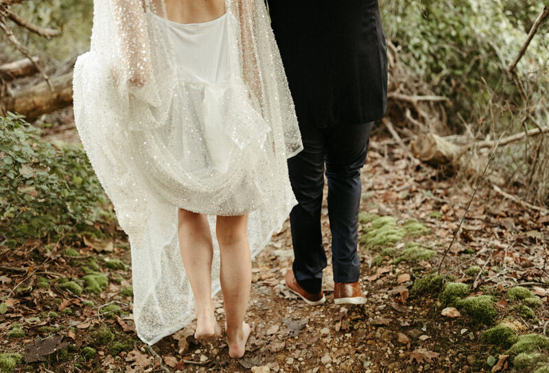 bride adn groom walking barefoot