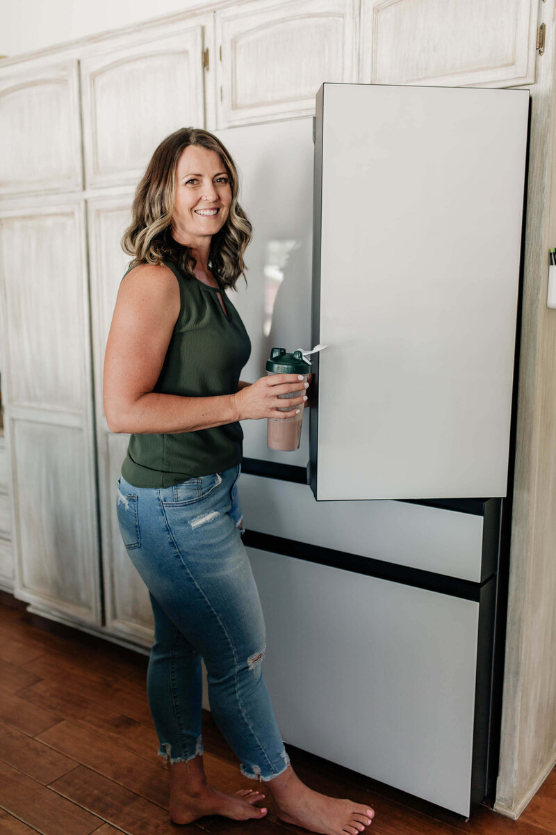 April at the fridge with her Shaklee Protein Shake in hand
