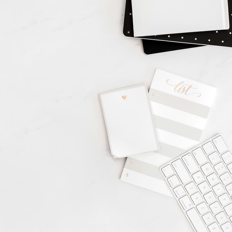 White home office with photos on the wall.