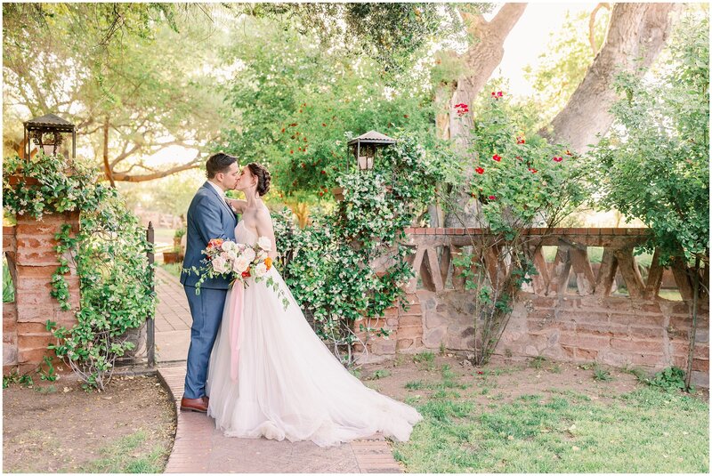 Bride and Groom share a kiss on their wedding day  at Agua Linda Farms Wedding Venue in Amado, Arizona