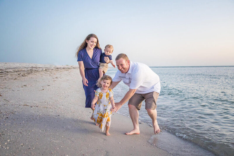 Las Vegas Photographer and her husband chasing their toddlers on the beach  in Florida