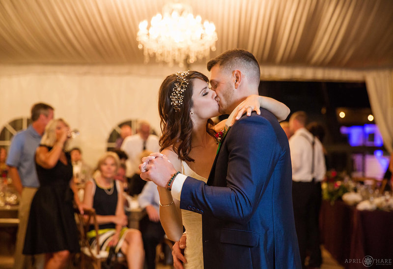 Wedding couple kiss during their first dance in the white tent at Wedgewood Weddings Boulder Creek