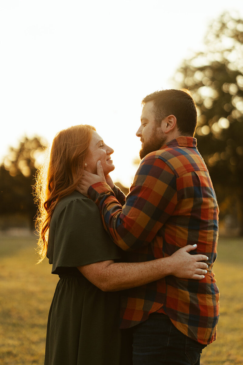 couple embracing each other at sunset