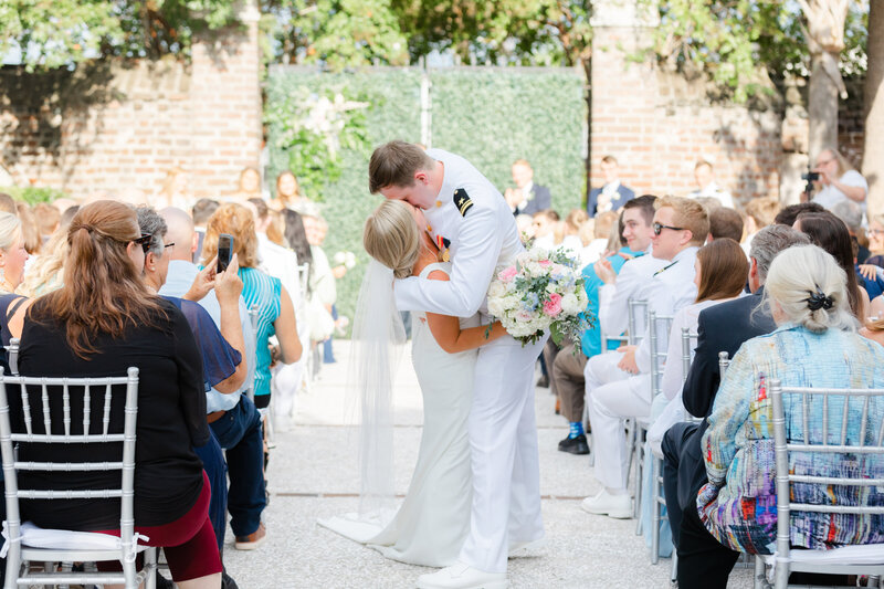 First kiss during wedding ceremony recessional at a military wedding in Charleston
