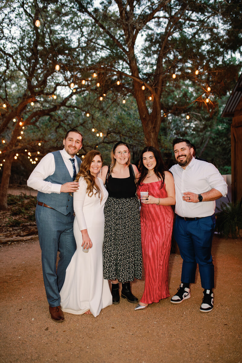 Tess Leslie poses with past and current clients at a Wildflower Barn wedding in Austin, Texas