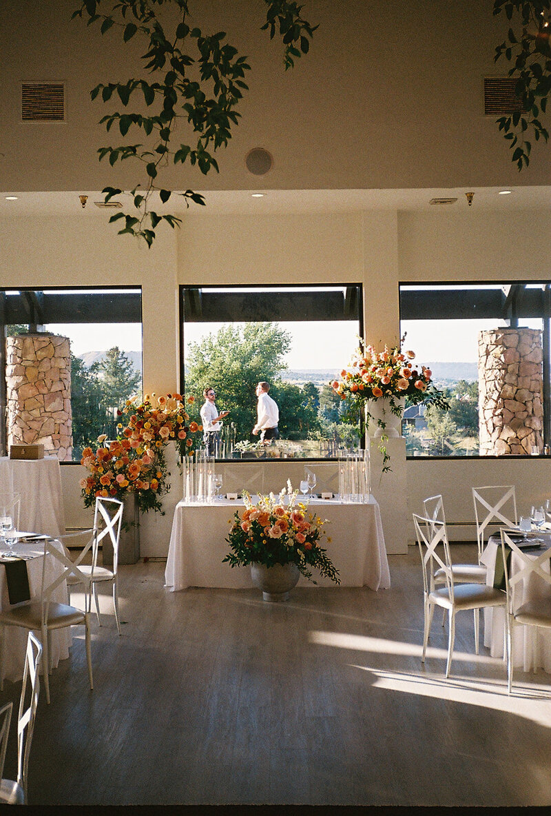 Unposed moment of wedding guests exchanging laughter under twinkling lights in Denver, Colorado.