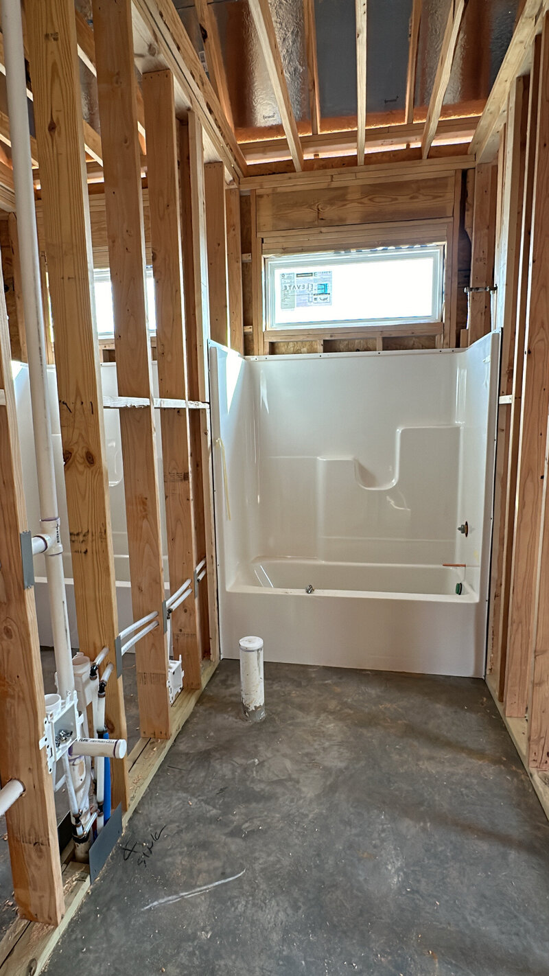 Photo of a newly installed bathtub in a new construction home.