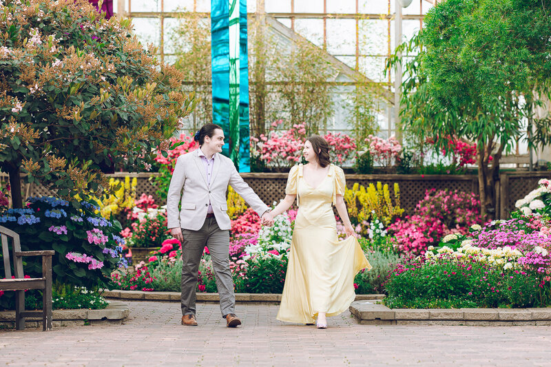 A couple walks through the Lincoln Park Conservatory during their engagement session
