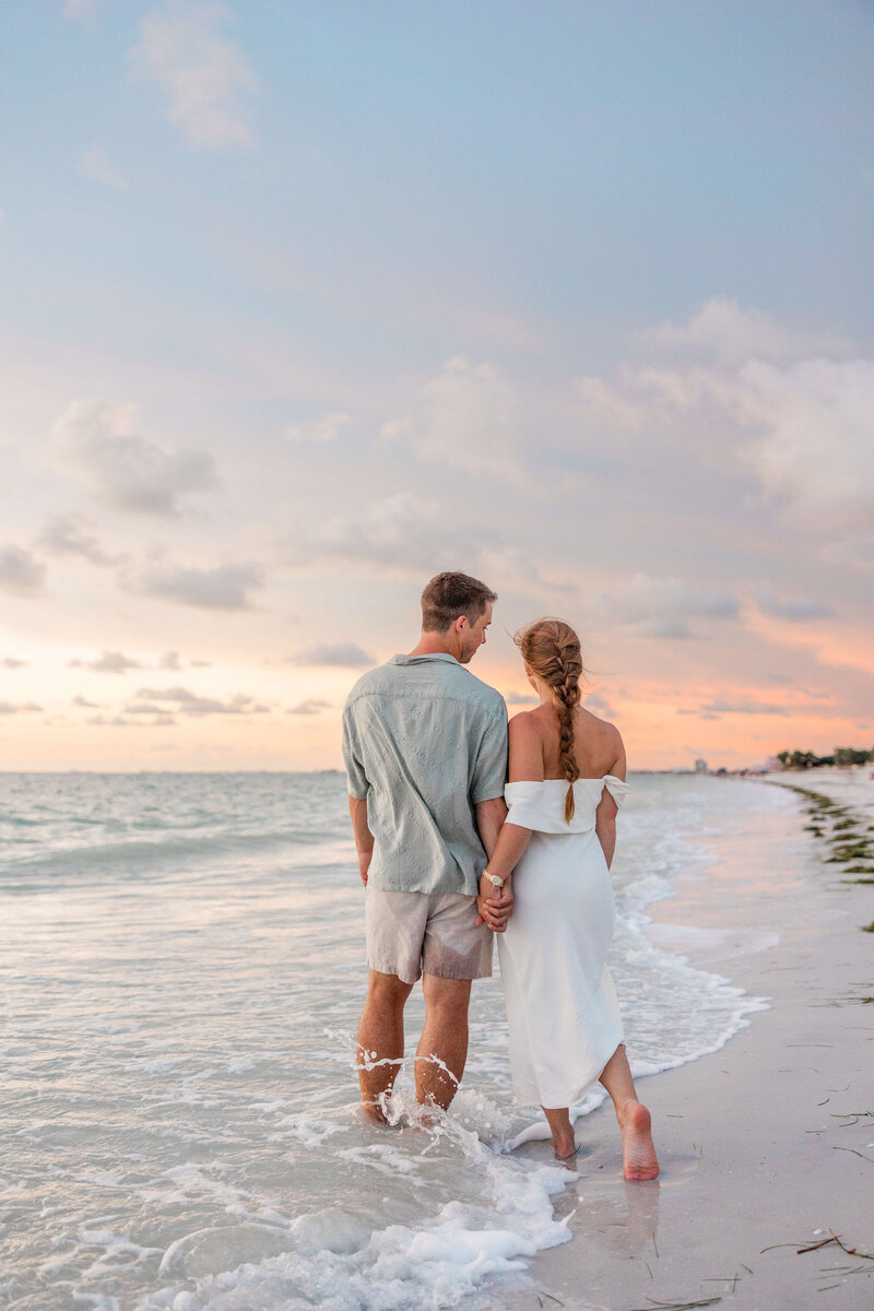 couple gets engagement photos taken at sunset on pass a grille beach