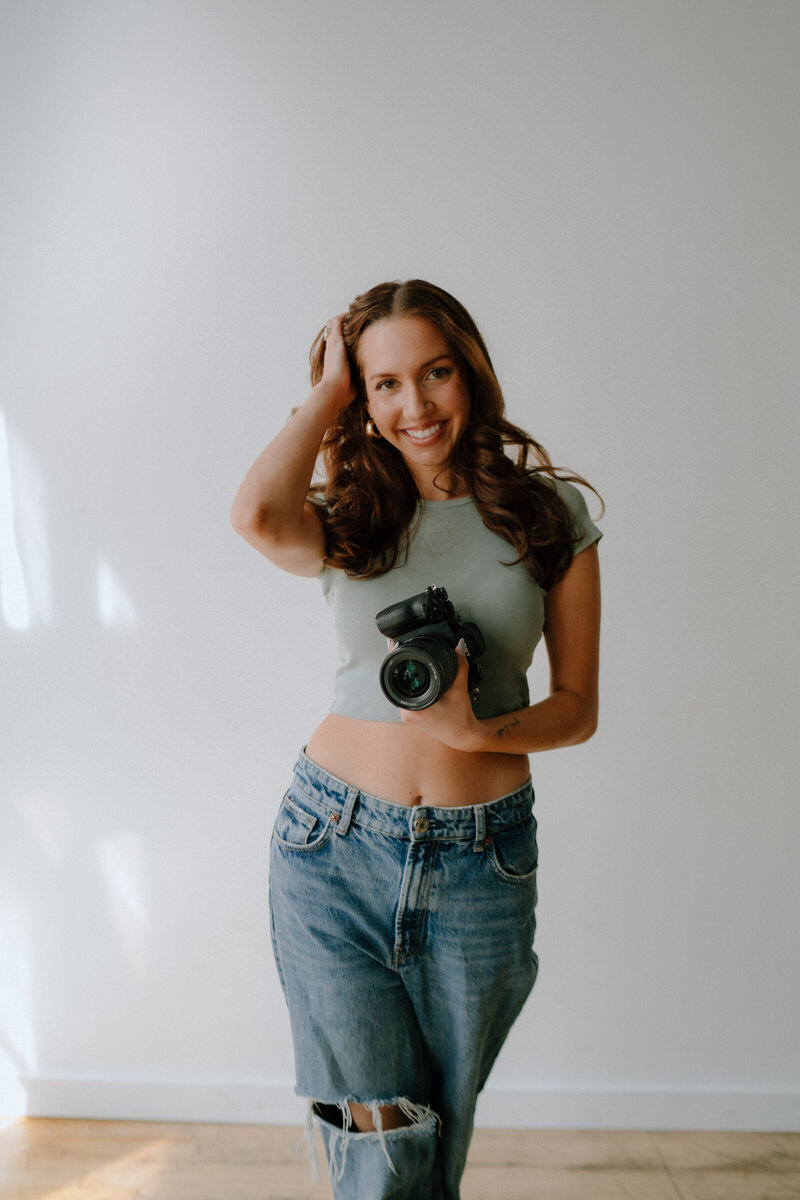 photographer holding camera and smiling