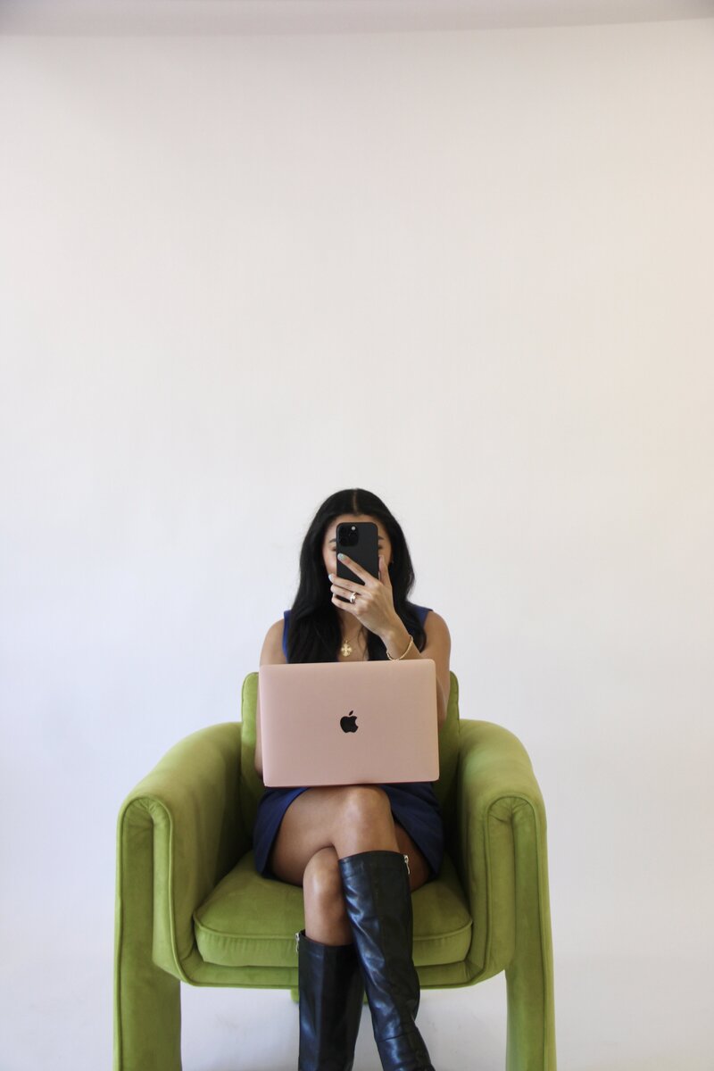 Bri holding an iPhone, symbolizing brand strategy and digital presence for small businesses