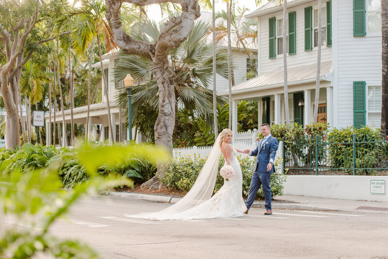 A bride and groom pose together in Key West