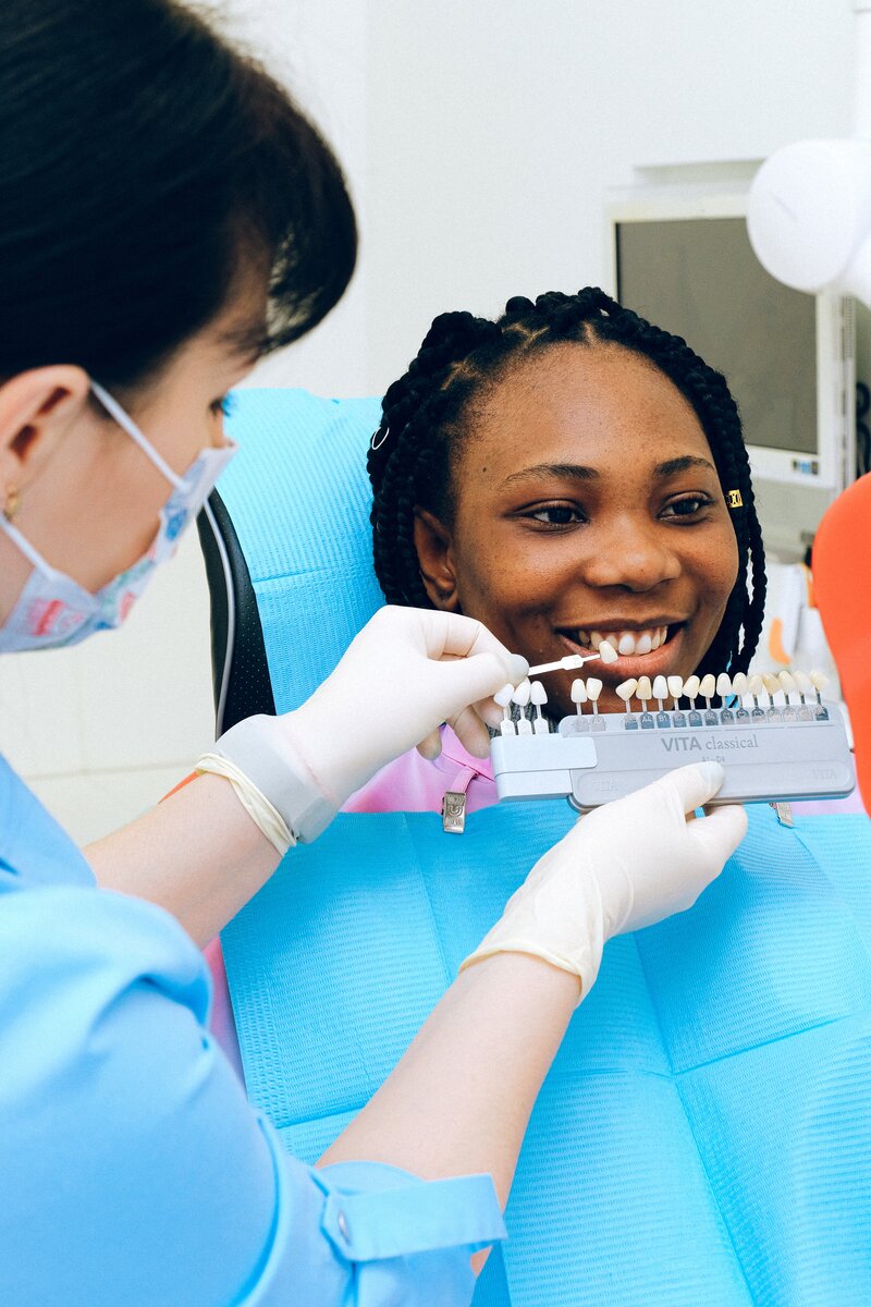 A dental assistant helps a patient discover how white she can get her smile.