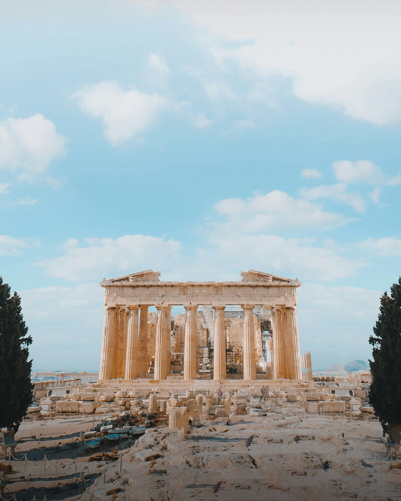 The Parthenon in Athens, Greece, a historic architectural masterpiece, captured under a bright blue sky.