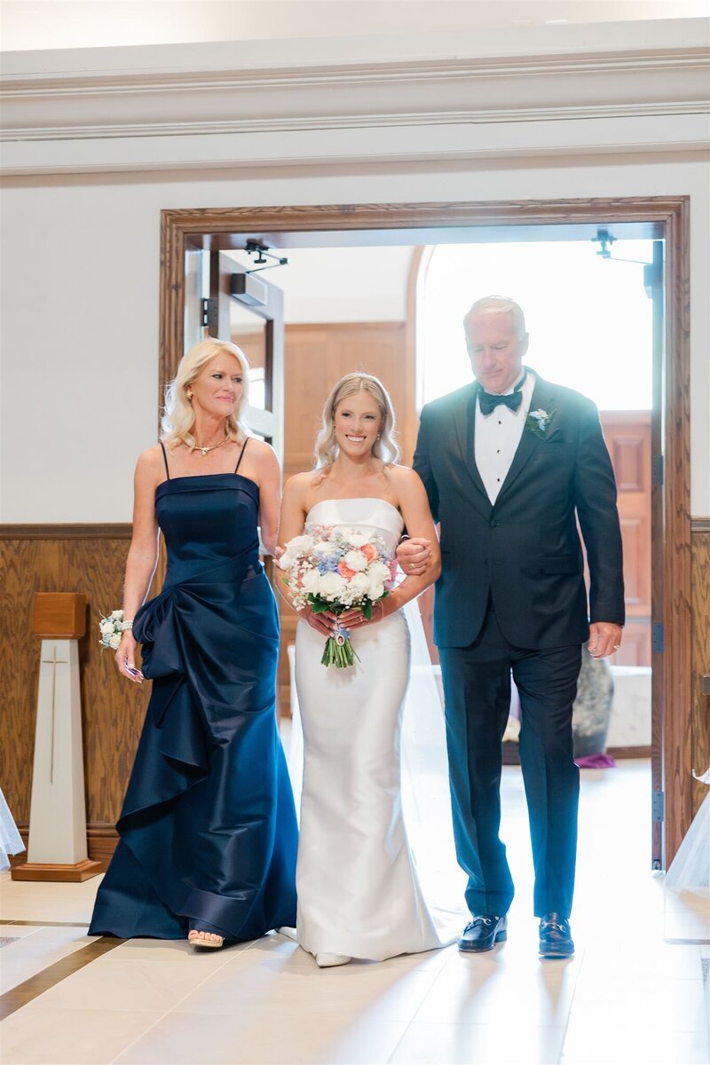 A bride walking down the aisle at a Catholic Church in Winter Park. 