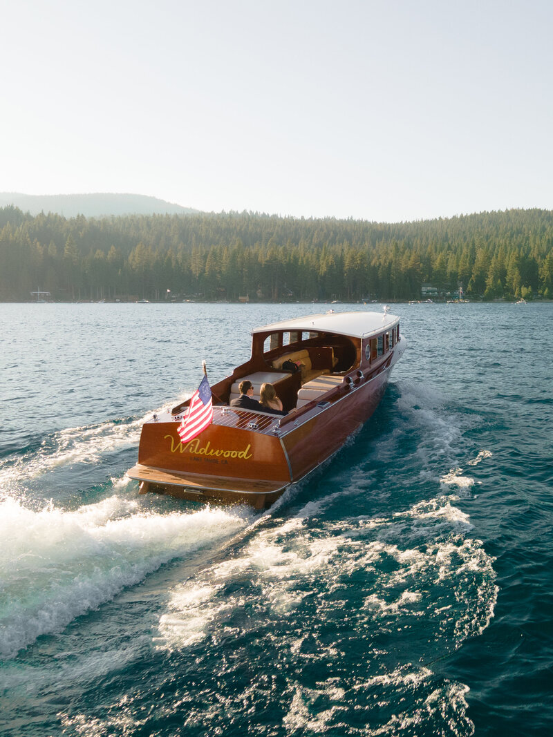 Lake Tahoe wooden boat elegant and luxurious engagement photo session during sunset