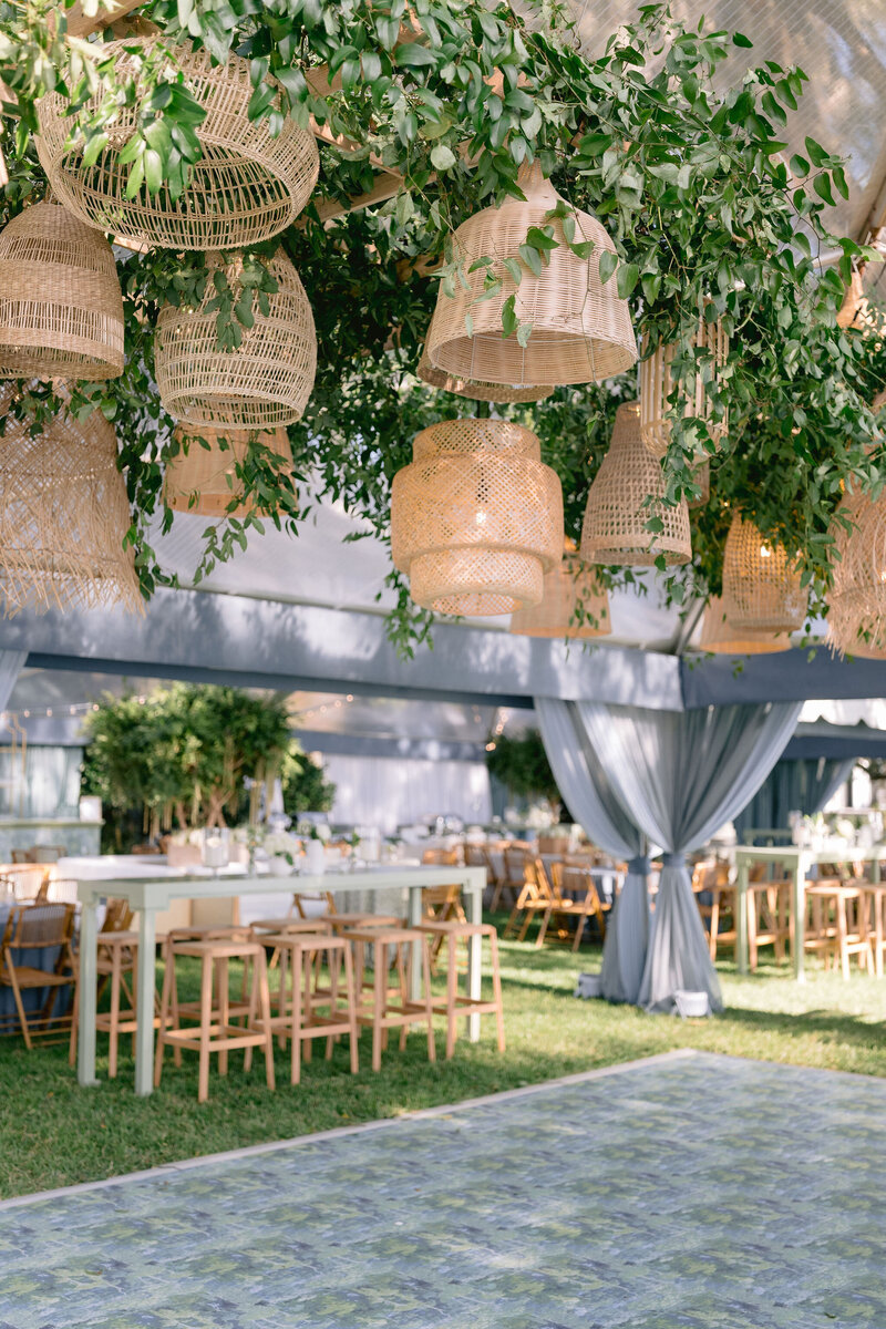 greenery and chandelier installation over wedding reception dance floor