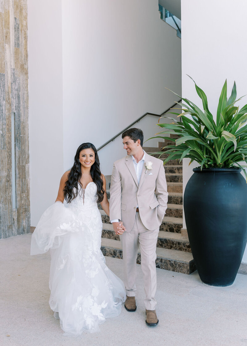 bride and groom walking at venue in Cabo San Lucas