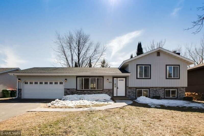 home exterior with white paneling and stonework exterior