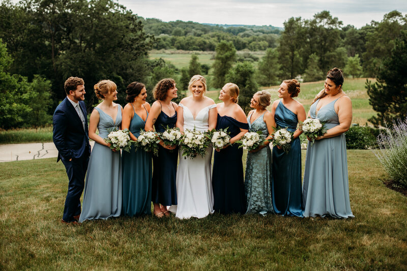 Bride and bridesmaids smiling at each other