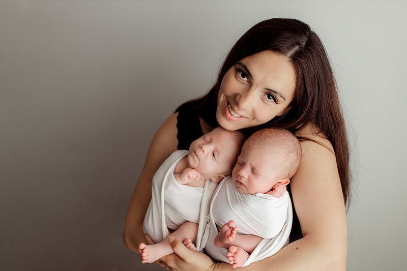 newborn-twins-cradled-by-her-mother