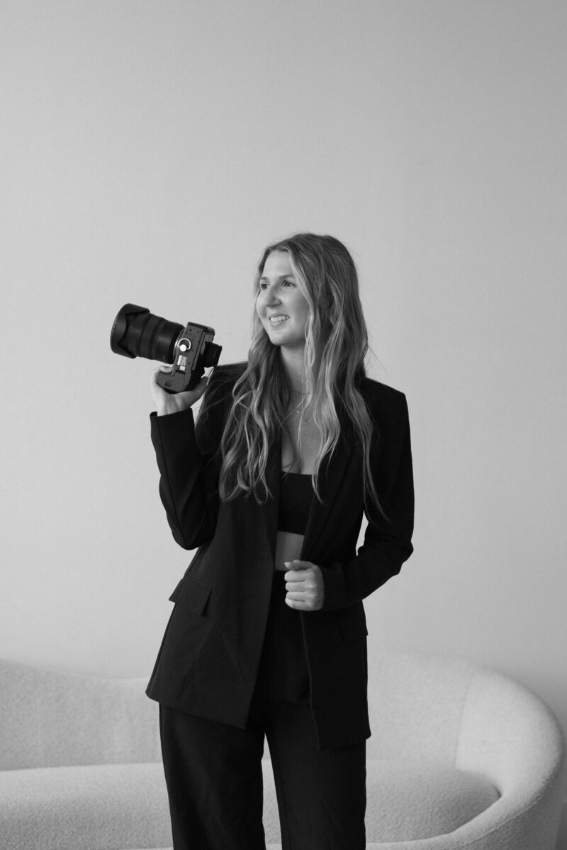 Portrait of a Midwest documentary wedding photographer with a warm smile, ready to capture heartfelt moments.