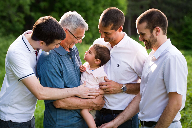 grandfather holding his grandson laughing with sons captured by Ottawa Family Photographer JEMMAN Photography