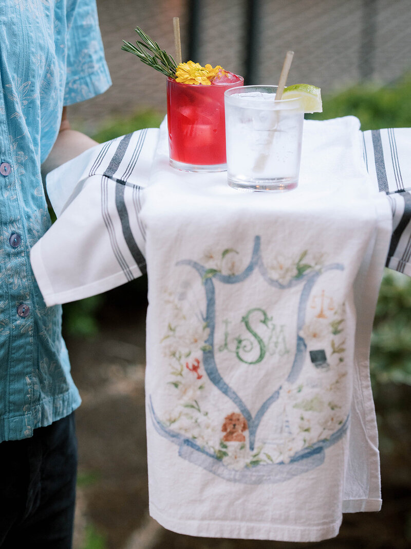 Server holding signature wedding drinks at reception planned by Bianca Nichole and Co
